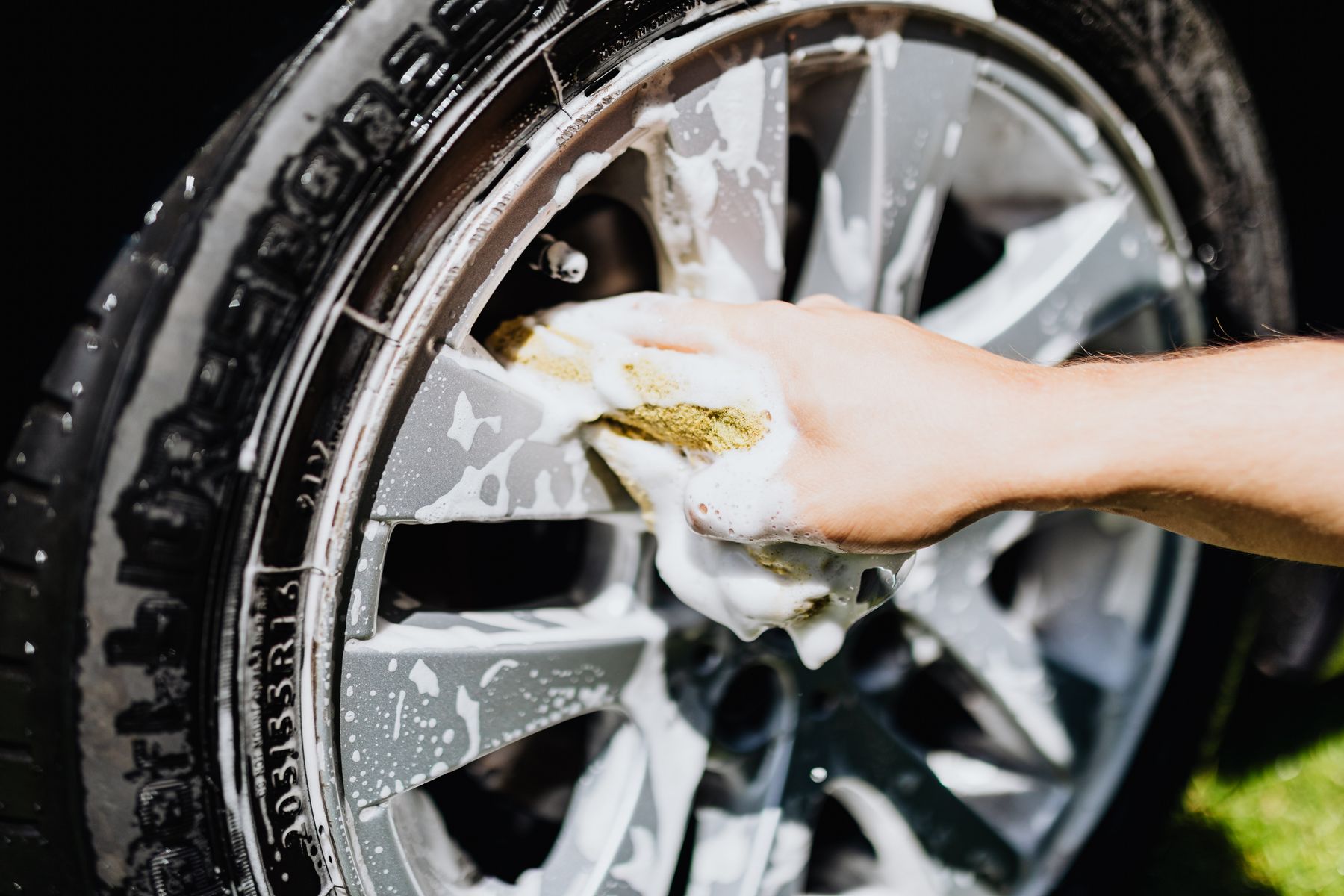 A wheel being cleaned by hand with soap suds